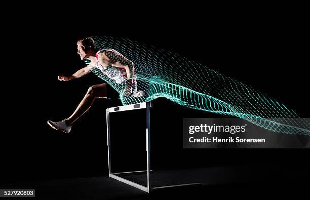 athlete with lighttrace - hurdling track event 個照片及圖片檔