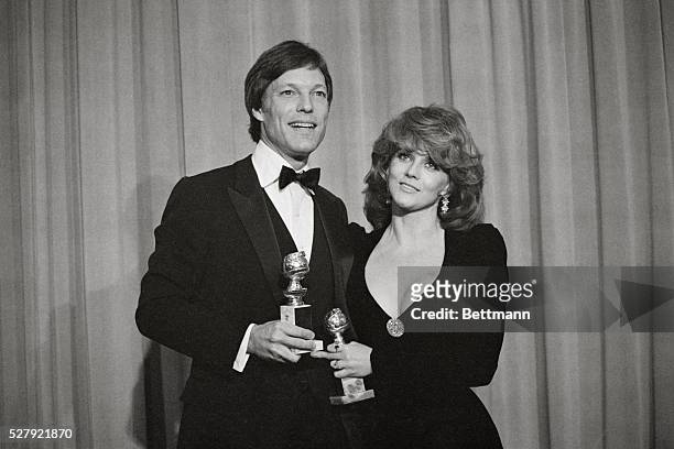 Actor Richard Chamberlain, , and actress Ann-Margret hold their Golden Globes Awards that they have just received at the 1984 Golden Globes Awards at...