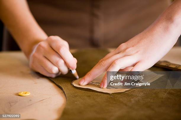 hands of young woman holding sewing pattern - schnittmuster stock-fotos und bilder