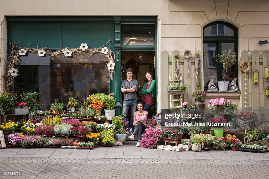 Flower vendors in doorway of shop