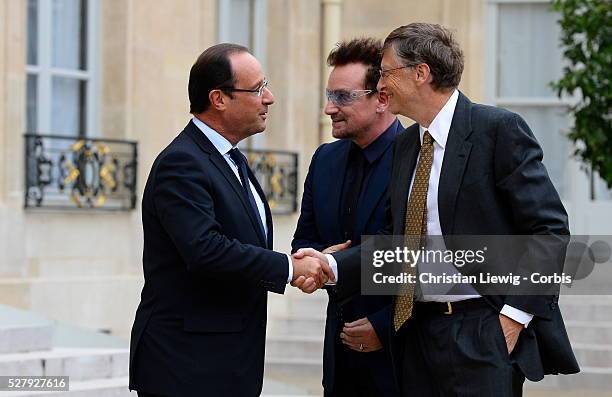 French President Francois Hollande welcomes Irish musician and humanitarian activist Bono and Microsoft co-founder turned global philanthropist Bill...