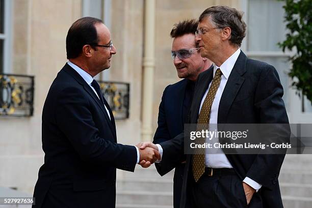 French President Francois Hollande welcomes Irish musician and humanitarian activist Bono and Microsoft co-founder turned global philanthropist Bill...