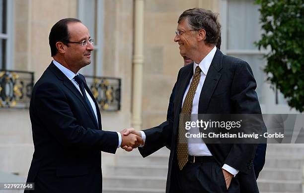 French President Francois Hollande welcomes Irish musician and humanitarian activist Bono and Microsoft co-founder turned global philanthropist Bill...