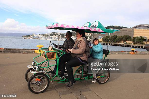 Family taking a discovery tour from Oriental Bay to Kumutoto on an Enormous Crocodile quadricycle on Wellington's waterfront Wellington, South...