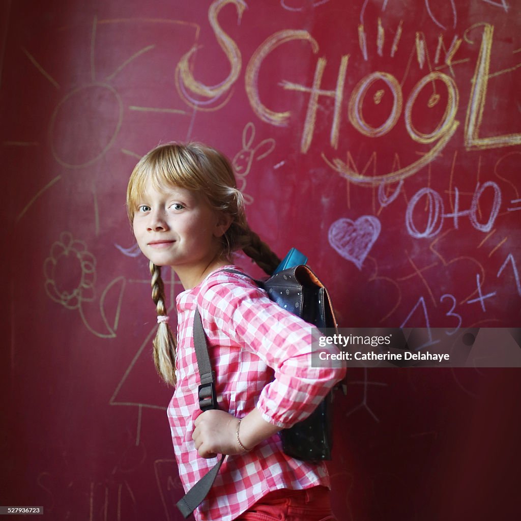 A 8 years old girl with a schoolbag