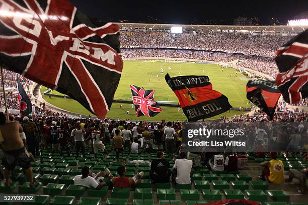 Flamengo fans supporting their team, waving flags and singing during the Flamengo v Vasco da Gama, Futebol Brasileirao 2010 League match at the...