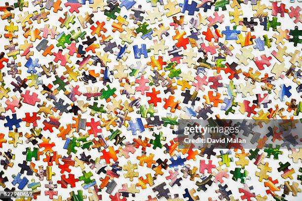 puzzle pieces on a white surface - pusselbit bildbanksfoton och bilder