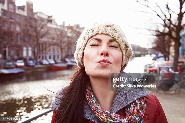 portrait of woman in wooly hat - blowing kiss stock pictures, royalty-free photos & images