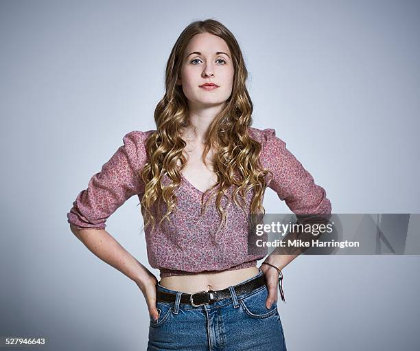 female with hands on hips looking direct to camera - confident looking to camera stock pictures, royalty-free photos & images