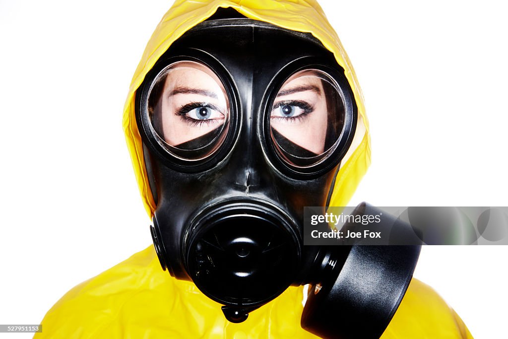 Woman wearing gas mask and protective clothing
