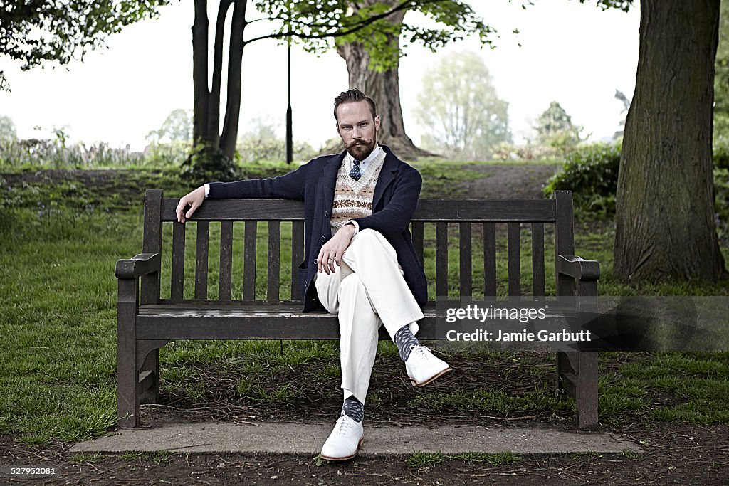 Retro styled male sat on a bench