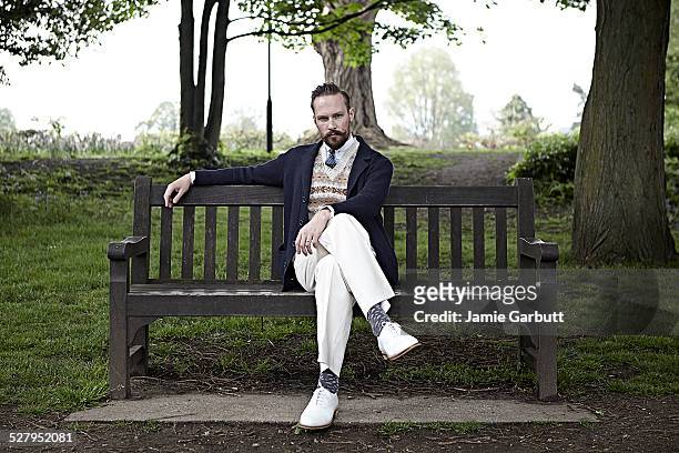 retro styled male sat on a bench - legs crossed at knee stock pictures, royalty-free photos & images