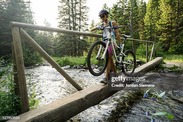 a woman mountain biking. - bozeman stock pictures, royalty-free photos & images