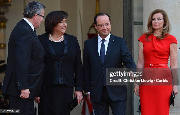 France President Francois Hollande and his partner Valerie Trierweiler pose with Poland's President Bronislaw Komorowski and his wife Anna Komorowska...