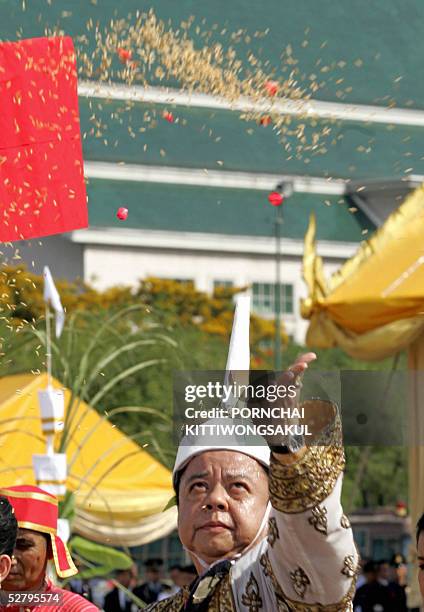 Thai chief of ceremony throws rice seeds during the annual royal ploughing ceremony in Bangkok, 11 May 2005. The Thai royal soothsayer predicted...