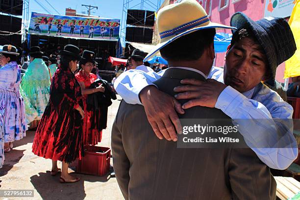 Virgen de la Candelaria. Drunken men embrace each other during the Fiesta de la Virgen de la Candelaria is held to honour the Virgen or the Dark...