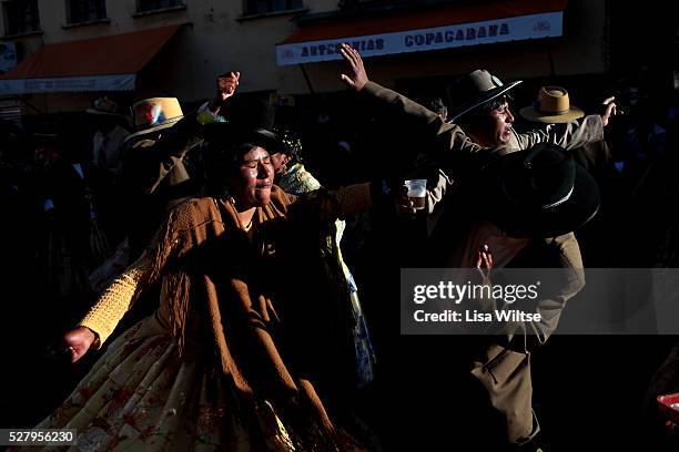 Virgen de la Candelaria. Aymarans drink and dance during the Fiesta de la Virgen de la Candelaria which is held to honour the Virgen or the Dark...