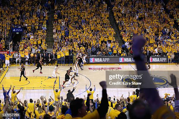 Fan celebrate after Harrison Barnes of the Golden State Warriors made a three-point basket against the Portland Trail Blazers during Game Two of the...