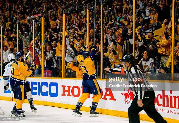 Colin Wilson celebrates with fans as referee Dan O'Halloran signals goal against of the San Jose Sharks during the third period of Game Three of the...