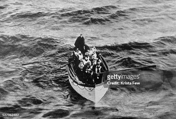 An emergency cutter lifeboat carrying a few survivors from the Titanic, seen floating near the rescue ship Carpathia on the morning of April 15,...