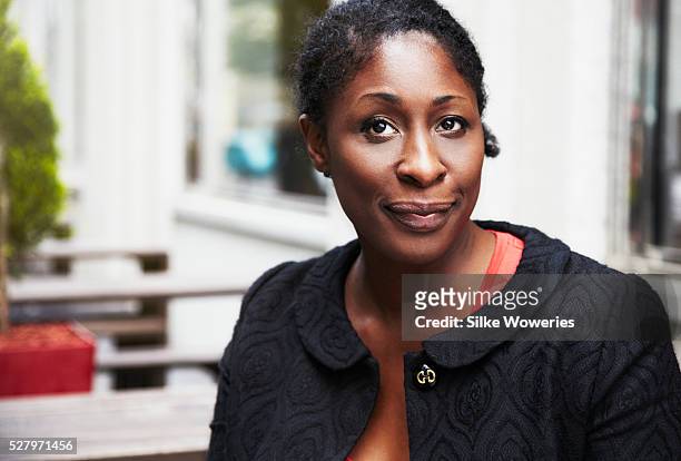 portrait of a content afro-american businesswoman - nigeria woman stock pictures, royalty-free photos & images