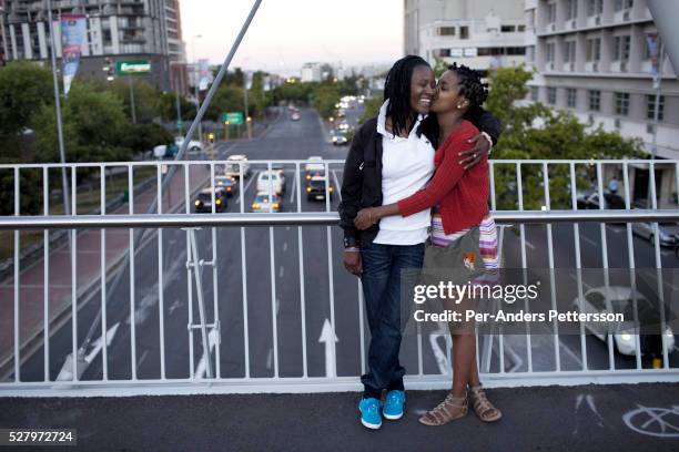 Natasha Mbisi and her girlfriend Zama Shange walks in the Cape Quarter gay area on December 16, 2011 in Cape Town, South Africa. Cape Town is a city...