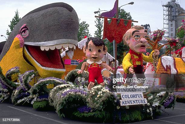 Float decorated with characters from the tale of Pinocchio, incl;uding the puppet-maker Gepetto, Pinocchio himself, and the whale. Grand Floral...