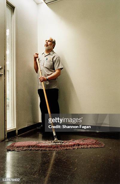 janitor sweeping floor - bidello foto e immagini stock