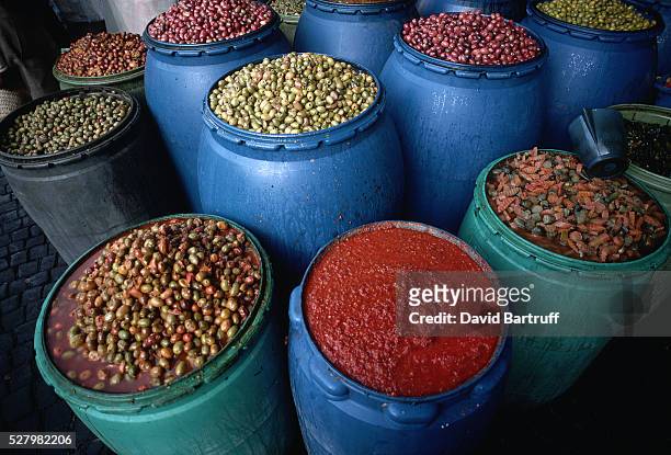 Barrels of olives and chili paste at a bazaar in Casablanca, Morocco.