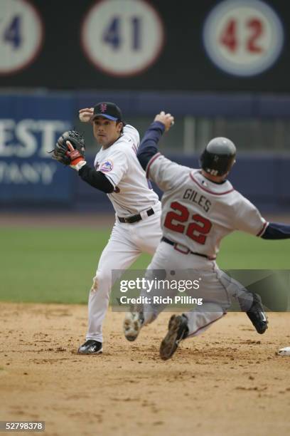 Kazuo Matsui of the New York Mets fields as Marcus Giles of the Atlanta Braves slides into second during the game against the Atlanta Braves at Shea...