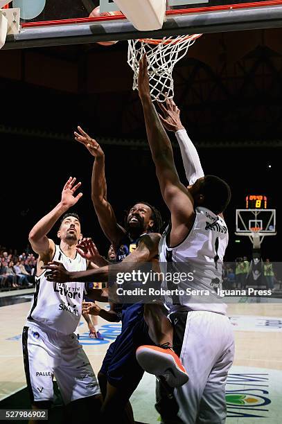 Ndudi Ebi of Manital competes with Valerio Mazzola and Dexter Pittman of Obiettivo Lavoro during the LegaBasket match between Virtus Obiettivo Lavoro...