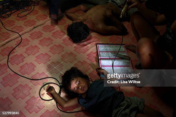 Young girl sleeps in Ulingan, a squatter community in the North Harbour of Manila, where families work as Ulingeros, or charcoal workers. Many of the...