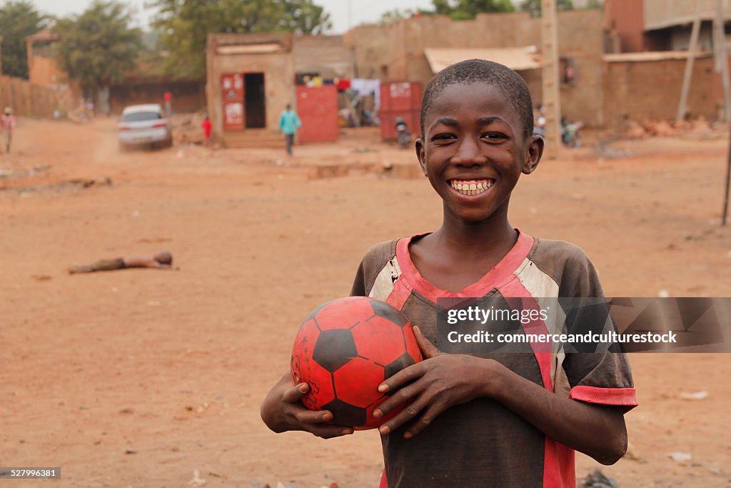 A smiling boy with a football