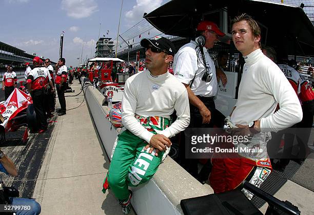 Tony Kanaan , driver of the Team 7-Eleven Andretti Green Racing Dallara Honda, looks on with teammate Dan Wheldon, driver of the Klein Tools/Jim Beam...