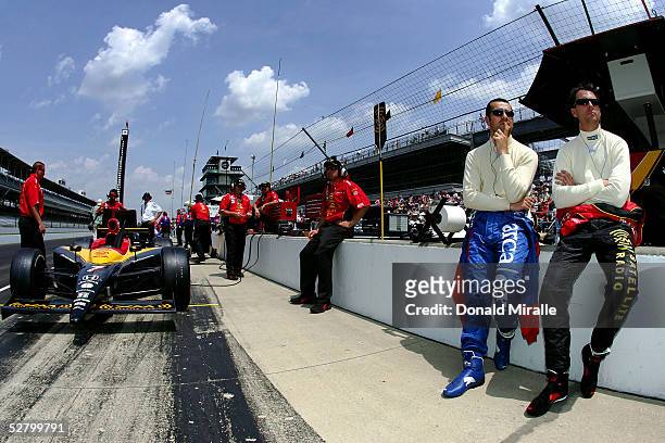 Dario Franchitti , driver of the ArcaEx Andretti Green Racing Honda Dallara looks on with teammate Bryan Herta, driver of the XM Satellite Radio...