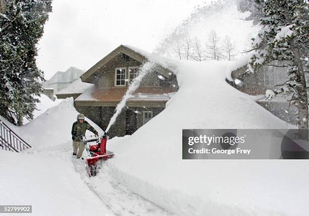 Clayton Hamblin clears almost two feet of new snow from some condominiums May 11, 2005 in Alta, Utah. There is already 178 inches of snow at...