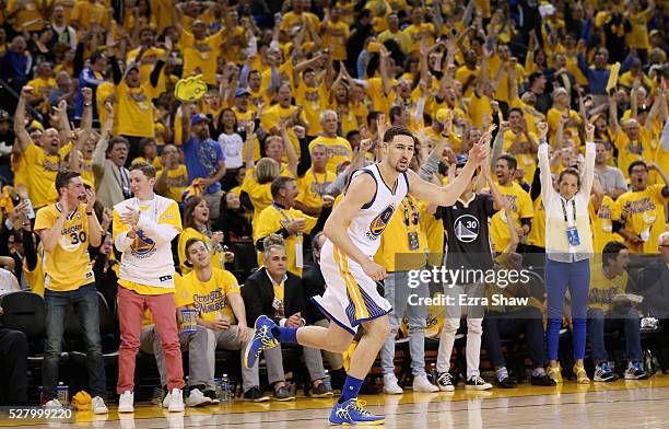 Klay Thompson of the Golden State Warriors runs back down court after making a three-point basket against the Portland Trail Blazers during Game Two...