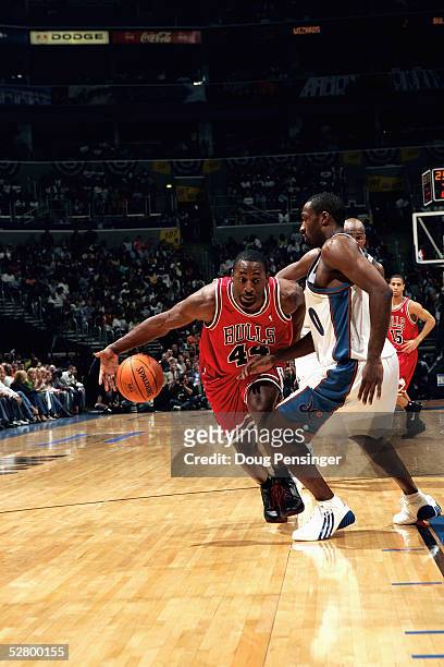 Adrian Griffin of the Chicago Bulls moves the ball against Gilbert Arenas of the Washington Wizards in Game five of the Eastern Conference...