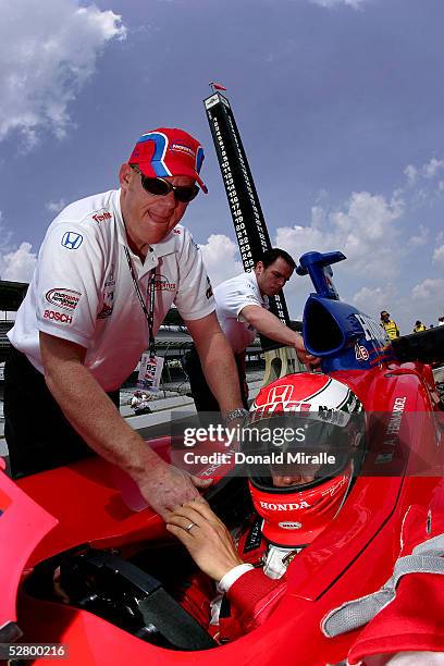 Adrian Fernandez, driver of the Investment Properties of America Mo Nunn Racing Panoz Honda, is strapped into his car by a crew member during...
