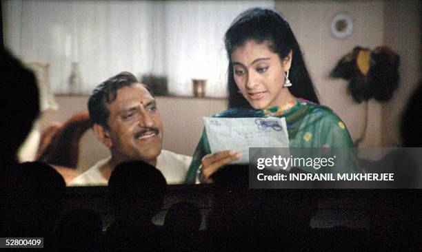 Movie goers watch the popular hindi film Dilwale Dulhania Le Jayenge at the city's prestigious Maratha Mandir movie hall in its matinee show in...