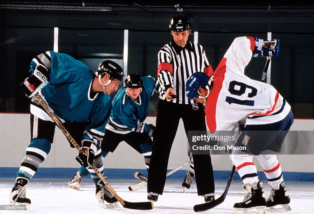 Referee Preparing to Drop the Puck