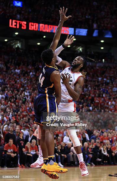 DeMarre Carroll of the Toronto Raptors watches his shot as Solomon Hill of the Indiana Pacers defends in the second half of Game Seven of the Eastern...