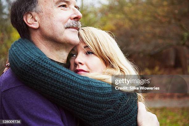 portrait of a senior father and his daughter standing in a park and embracing each other - admiration photos et images de collection