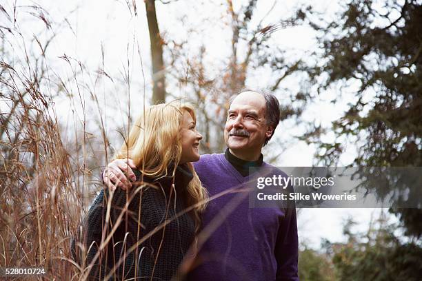 father and daughter going for a walk on an autumn's day and talking - old man young woman stockfoto's en -beelden