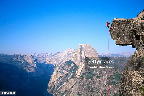 man rappelling from glacier point - half dome stock pictures, royalty-free photos & images
