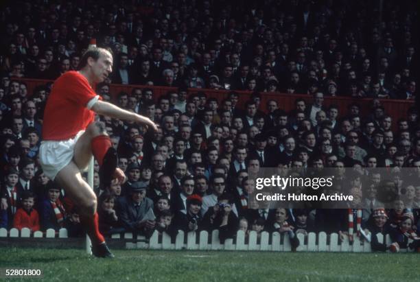 English footballer Bobby Charlton taking a corner for Manchester United, 1968.