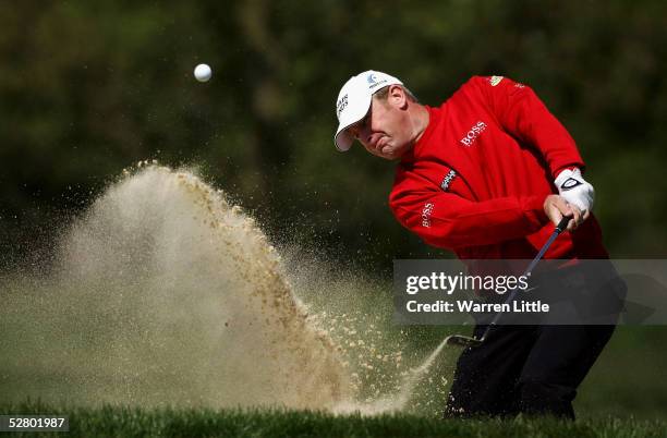 Gary Evans of England plays out of the greenside bunker on the third hole during the first round of The Daily Telegraph Dunlop British Masters at the...