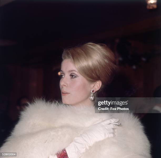 French actress Catherine Deneuve arriving at a Royal Film Performance of James H. Hill's movie 'Born Free', at the Odeon, Leicester Square, London,...