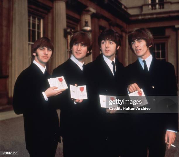 British pop group The Beatles, from left to right; Ringo Starr, John Lennon , Paul McCartney and George Harrison , outside Buckingham Palace, London,...