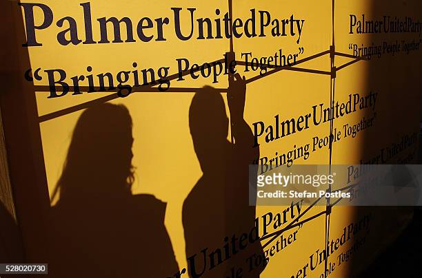 Palmer United staff secure a sign during a press conference at Parliament House on May 4, 2016 in Canberra, Australia. The Turnbull Goverment's first...